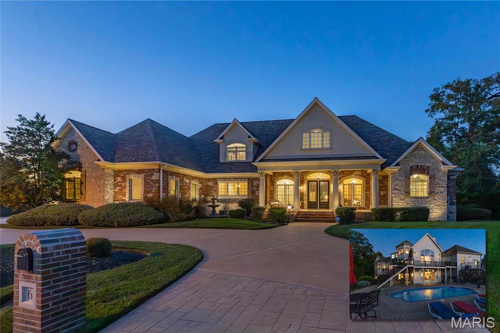 Introducing 6 Hansen Manor, an exceptional lakefront luxury estate in the gated Spring Mill community. Tucked at the end of a quiet cul-de-sac on an extraordinary 2.15-acre waterfront homesite, this Fischer & Frichtel-built residence offers over 9,600 square feet of refined living space, resort-style outdoor amenities, and a combination of privacy, acreage, and lifestyle that is increasingly difficult to find. For buyers seeking premier homes with gated community appeal, lake views, a pool, a main-floor primary suite, and a thoughtfully designed layout with ample room for entertaining, this property stands in a class of its own.

Created for both gracious entertaining and comfortable daily life, the home features a grand foyer, dedicated office, formal dining room, dramatic great room, vaulted hearth room, well-appointed kitchen, breakfast room, butler’s pantry, and five fireplaces. The beautifully finished kitchen includes premium cabinetry, granite countertops, commercial-grade appliances, and a recently upgraded 6-burner Wolf cooktop. Large windows capture tranquil water views and fill the interior with natural light. The main level also includes a spacious laundry room with abundant cabinetry, generous counter space, and two closets, along with a substantial mudroom featuring floor-to-ceiling cabinetry, a full bath, and direct access to the oversized four-car garage. A powder room adds further convenience. The main-floor primary suite serves as a private sanctuary with fireplace, bay window, private deck, spa-inspired bath, and two spacious walk-in closets.

Upstairs, two ensuite bedrooms with walk-in closets, flexible bonus space, a well-equipped kitchenette with sink, cabinetry, built-in microwave, and dishwasher, plus a finished luggage/storage room, provide comfort and versatility for family, guests, or longer-term stays. The walkout lower level is equally impressive, offering a family room, full kitchen, theatre/media room, two ensuite bedrooms with walk-in closets, crafts room, library, second laundry area, safe room, powder bath, and ample storage, making it ideal for multigenerational living, gracious entertaining, recreation, or extended stays.

Extensively improved and very lightly lived in, this home pairs timeless architecture with thoughtful modern refinement. Recent improvements include hardwood flooring in the primary suite, kitchen, and hearth room; new porcelain flooring in the mudroom, bath, and laundry; carpet in the great room; recently replaced HVAC and two 75-gallon water heaters; quartz countertops, sinks, and faucets in multiple service areas; lighting enhancements, including designer chandeliers; remote window treatments; security with exterior cameras; a refined theatre with Sony 4K projection and improved sound; and refreshed pool equipment.

Outdoor spaces are equally compelling, with a pool, deck, patio, lush landscaping, LED landscape lighting, and peaceful lakefront surroundings spread across 2.15 acres, creating a serene retreat at home. Spring Mill offers the appeal of a prestigious gated neighborhood with a walkable setting, scenic beauty, and convenient access to shopping, dining, parks, trails, major interstates, airports, hospitals, universities, and the greater St. Louis region.

A distinctive opportunity to own a signature home with waterfront views, acreage, flexible living areas, and the elevated lifestyle sought by discerning, executive, and relocation buyers alike.