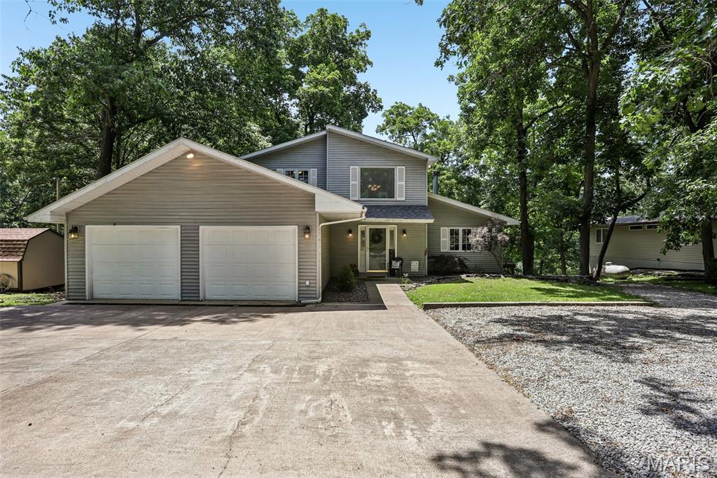 More Than a Home - A Lakefront Lifestyle! 4 bedroom, 3 bath home offers the perfect blend of comfort, recreation, and lakeside living. The main level features two spacious bedrooms, a full bath, a recently remodeled eat-in kitchen, and a welcoming living room highlighted by a cozy fireplace. Upstairs, you'll find a primary retreat complete with a large bedroom, en suite full bath, and a relaxing sitting area that's perfect for unwinding after a day on the water. The walkout lower level provides even more living space with an additional bedroom and full bath, a large family and recreation room, plus ample storage. Whether you're hosting guests or creating the ultimate entertainment space, this level offers endless possibilities. Step outside and take in everything lake living has to offer from the multiple decks, including a lakeside deck ideal for entertaining, relaxing, or simply enjoying the view. Located near all the activities and recreation that Lake Lou Yaeger has to offer, this property is ready to become your year round residence or weekend getaway. Don't miss your opportunity to make this lakeside dream a reality - call today to schedule your private showing!
