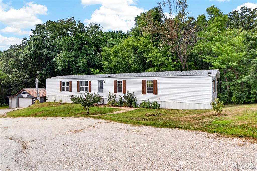 FRESHLY UPDATED AND MOVE-IN READY! Step inside to brand-new flooring and fresh interior paint throughout this spacious 4-bedroom, 2-full bath home at 1203 Highway J. Offering a bright, turn-key layout, this home delivers the perfect blend of updated living and country privacy, all situated on a private 1-acre lot with NO HOA restrictions!

Outside, the highlight is a massive 4-car detached garage and workshop, ideal for car enthusiasts, tradespeople, hobbyists, or extra equipment storage. Enjoy the freedom of a sprawling yard with endless room to entertain, park your boat or RV, and unwind, all while staying just minutes from local Troy amenities. Whether you need workshop space, room for the family, or a quiet retreat without HOA rules, this move-in ready property is a must-see!