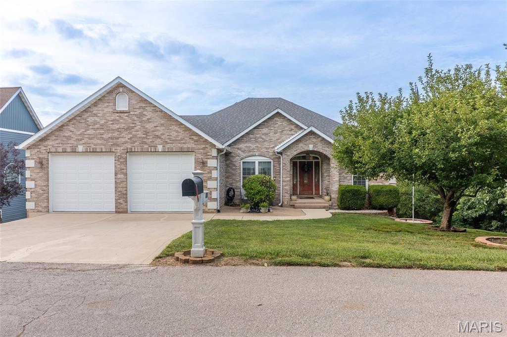 Lake life meets luxury in this gorgeous atrium ranch in Raintree Estates!  This stunning 5-bedroom, 3-bath custom home sits nicely along the 4th hole of the golf course and comes loaded with unique features.  The custom kitchen includes high-end appliances, a breakfast nook, a breakfast bar, and pairs well with the separate dining room.  The spacious great room has vaulted ceilings, a propane fireplace and leads to the back deck with a lake view!  The large laundry room is just off the kitchen and leads to the oversized garage.  The primary bedroom boasts coffered ceilings, a walk-in closet, a walk-in shower, a jacuzzi tub, and dual vanity sinks.  The lower level is well suited for entertainment and enjoyment alike with its pool table, second kitchen, bar, and more.  The 5th bedroom currently serves as an office but could be used as a craft room or more.  It too has a great view of the fairway and lake!  There’s also an additional bedroom, bathroom and storage room with a storm shelter.  Just off the basement is a second garage and workshop.  The workshop is nicely positioned with generous space and branches off the lower-level garage.  The lower-level garage has rear entry and its own driveway, making it a great fit for a golf cart!    Adjacent to the garage is a large, partially covered patio with rear entry, deck access, a fire pit area, custom retaining walls, and landscaping.  A utility room sits next to the workshop and includes a second washer/dryer hook-up, a utility sink, and, in fact, served as an exercise room.  By pairing the basement garage with an extra bedroom, bathroom, laundry hook-ups, and kitchen, it’s like having 2 houses in one!  The Raintree Community also has so much to offer.  The gated community has two lakes to enjoy, a golf course, restaurant/clubhouse, campground, pavilion, and a white sandy beach!  With the endless golfing, boating, tubing, skiing, fishing, and more to be had, you can live like you’re on vacation.  Land your catch in this incredible lake community today, or this unique property will get away!

The vacant lot across the street, facing the house is included in sale (Parcel 12-9.0-29.0-3-003-091). Lot size is .26 acres. Pool table, dining room set and tanning bed may stay with house and be included in sale.