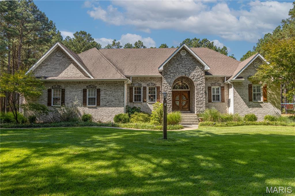 Tucked among mature evergreens on a beautiful 3.9-acre setting, 20 Deer Trail offers the privacy of a retreat with more than 4,200 square feet of combined living space and an impressive collection of amenities inside and out. Built in 2009, the brick and stone home features 4 bedrooms, 3.5 baths, custom cabinetry, two gas fireplaces, walk-in showers, a four-seasons room, double refrigerators and a wine fridge. The finished lower level adds even more flexibility with a kitchenette and additional washer/dryer hookup—ideal for guests, entertaining, extended stays, or multi-generational living. Outside, this property truly sets itself apart. An in-ground pool and pool house create your own backyard getaway, while a separate workshop and 4-car garage with epoxy flooring provide exceptional space for vehicles, hobbies and storage. Thoughtful upgrades include a whole-house generator, separate water heater for the primary suite, surround-sound wiring and speakers, security system, sprinkler system and dusk-to-dawn exterior lighting. Nearly four acres. Over 4,200 square feet. A pool, pool house, workshop and four-car garage—all in one property. 20 Deer Trail is one you'll want to experience in person.