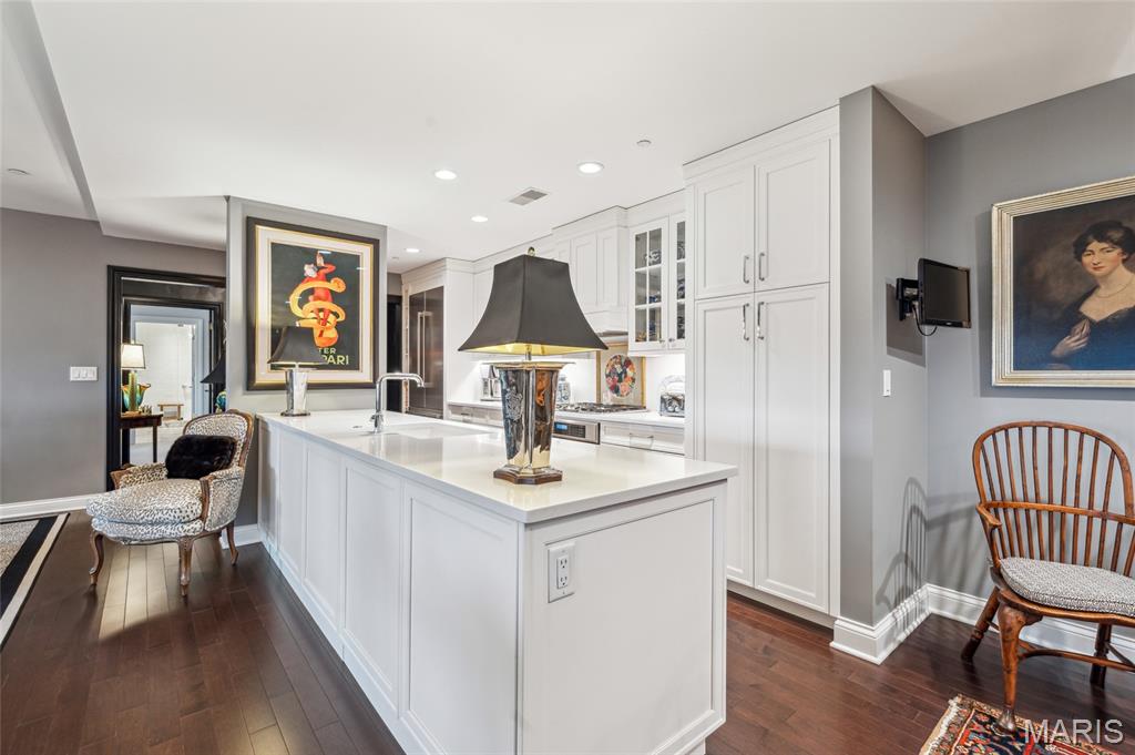 Absolutely stunning condo with incredible views of Forest Park! 2 bedrooms, 2.5 bathrooms, 2,068sqft of living space and secured garage parking spaces(2). Greet guests in large entry foyer w/hand painted walls, marble tile and coffered ceiling. New hardwood flooring throughout living, dining room with coffered ceilings, recessed lighting and a study which features a double-sided gas fireplace and built-in bookshelves. Updated kitchen w/Thermador appliances, custom hood, 5-burner gas range, custom backsplash, dishwasher, quartz countertops and breakfast room. Primary suite w/newer carpet, coffered ceiling, large walk-in custom closet, raised vanity sink, marble flooring, quartz countertop, subway tile walk-in shower & jetted tub. Private second bedroom ensuite includes updated full bathroom w/raised vanity, quartz counter, grasscloth wallpaper, walk-in shower and large walk-in closet. In-unit laundry w/Bosch washer/dryer and designer half bath. NEW interior storm windows & NEW HVAC! Amenities: green terrace w/gas fireplace, 2 Wolf gas grills, community room w/full kitchen, valet parking, concierge, dry cleaning collected/delivered twice/week, on-sight security, storage area, bike room, restaurants(3), movie theater & heated pool! Straub's across the street and walkable to all CWE has to offer!