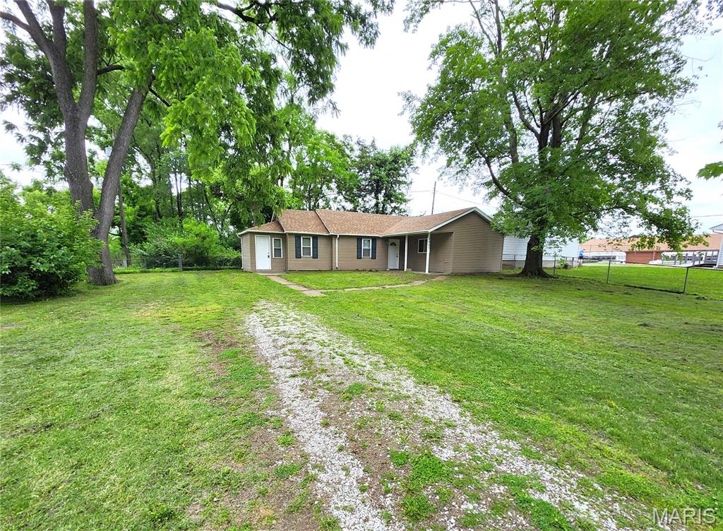 Why rent when you can own this affordable 2-bedroom ranch on a huge fenced in lot. This is a great location to store that boat, extra trailer or work vehicle & equipment without the worry of an HOA to deal with. It's move in ready and  will make a perfect home or investment property. A new roof was just installed a few months ago (2026).  Inviting covered front porch for lounging in the shade. Large living room. Eat in kitchen with ample cabinetry and counter tops, plus a double sink. The stove & refrigerator are included.  Primary bedroom with plenty of space for a king-sized bed & accessories. The bathroom comes stocked with a stackable washer n dryer unit. Another large bedroom rounds out this priced to sell home. Vinyl double pane windows. Central Air & Furnace (2015) Newer Water Heater. Conveniently located just off of IL-Route 3, and 5 minutes from I-270 & the McKinley Bridge. 35 minutes to Scott AFB.