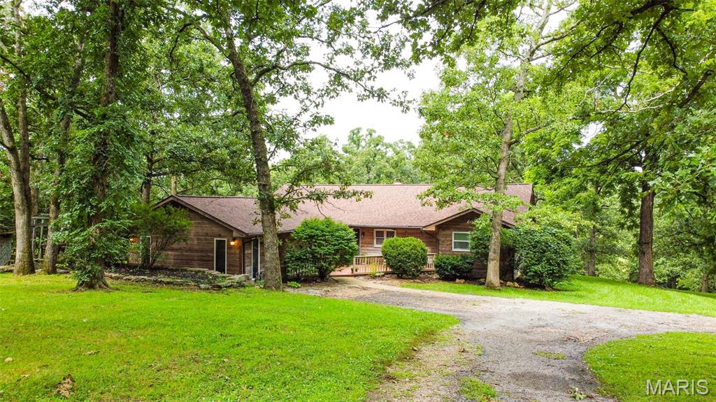 Escape to your own private retreat where space, nature, and endless potential come together. Nestled on 10 picturesque acres, this unique property offers approximately 3,067 square feet of living space and an exceptional opportunity to create the home of your dreams while enjoying an incredible natural setting.

Inside, you’ll find four spacious bedrooms, two full bathrooms, multiple office and flex spaces, and two oversized living areas designed for gathering and entertaining. One of the living rooms features a stunning floor-to-ceiling brick fireplace with a wood-burning insert, creating a warm and inviting focal point, while the built-in bar provides the perfect space for hosting family and friends.

The home has already seen several important improvements, including a newer roof, newer decks, newer appliances, and hvac systems. While some cosmetic updates would allow you to add your own personal style, the generous floor plan and quality features provide an outstanding foundation.

Step outside to experience what truly sets this property apart. The rolling 10-acre setting offers privacy, abundant wildlife, and breathtaking views, with beautiful Beaver Creek bordering the back of the property. Beyond the creek, the land adjoins Missouri Department of Conservation public land, giving you direct access to acres of mostly forested recreational opportunities. Enjoy nearby hiking trails, an archery range, picnic pavilion, and endless opportunities for outdoor adventure right outside your back door.

Additional features include a large detached garage with ample room for vehicles, equipment, hobbies, or workshop space. Whether you’re searching for a peaceful full-time residence, a weekend getaway, or a property with room to grow, this one offers a rare combination of acreage, recreation, and potential in an unforgettable setting.

If you’ve been dreaming of country living with the convenience of public conservation land just beyond your backyard, this is a property you won’t want to miss.