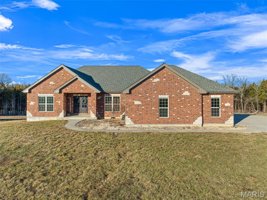 CONTINUE TO SHOW!! KICK-OUT CLAUSE! Exceptional custom-built all-brick ranch home nestled on 15.42 unrestricted acres, offering the perfect blend of luxury, privacy, and functionality. Thoughtfully designed with 4 bedrooms on the main level plus a private office, this home features soaring 10’ and 9’ ceilings and hardwood flooring throughout, creating an open and elegant atmosphere. The spacious great room is anchored by a stunning floor-to-ceiling stone fireplace, providing a striking focal point and a warm gathering space for family and guests. The primary suite is a true owner’s retreat, showcasing a coffered ceiling, spa-inspired jacuzzi tub, expansive custom-tiled double shower, separate double vanities, water closet, and a generous walk-in closet. The gourmet kitchen is equally impressive, featuring custom cabinetry, an oversized 5x9 center island, quartz countertops, tile backsplash, under-cabinet lighting, Jenn-Air appliances, stainless steel apron-front sink, and a walk-in pantry—perfect for entertaining and everyday living alike. Step outside to enjoy the expansive maintenance-free covered and uncovered deck, ideal for relaxing or hosting while taking in the peaceful views of the surrounding acreage. The finished walk-out lower level offers a large family room, additional bedroom, full bath, dedicated gym area, and a tornado room, providing flexible space for guests, recreation, or extended living. Additional highlights include a solar panel system for energy efficiency, an inground pool for summer enjoyment, and a wood-burning stove for added warmth and charm. With unrestricted land, ample space, and exceptional craftsmanship throughout, this remarkable property offers endless possibilities and a rare opportunity to enjoy refined country living at its finest. SELLER IS OFFERING A LANDSCAPE ALLOWANCE/CREDIT AT THE TIME OF CLOSING!