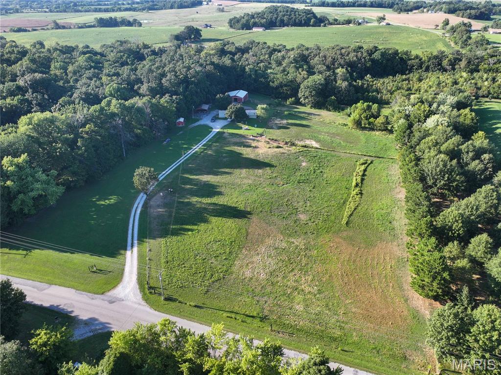 Land in northern Cape Girardeau County is hard to find, and this property offers a little bit of everything! Situated on approximately 7 acres m/l with blacktop road frontage, this property features a 1,216 sq. ft. modular home offering 3 bedrooms and 2 bathrooms. The home has received numerous updates over the past few years, including a new air conditioner and new windows. Outside, the acreage is set up and ready for horses or livestock with fully fenced pasture, a 36' x 50' horse barn with a 12' x 50' lean-to, a good-sized carport, and a small cooled utility shed. A private well serves the property. Located in the Oak Ridge School District, the acreage also offers potential for an additional homesite, providing options for extended family, future development, or investment. Whether you're looking for a small acreage homestead, a place for horses or livestock, or simply room to enjoy country living, this hard-to-find property is worth a look.