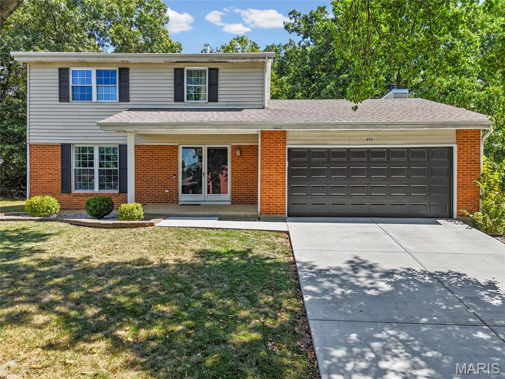 Welcome to 474 Oak Hill Dr—a rare opportunity to secure a highly functional layout paired with the ultimate Lake St. Louis resort lifestyle! Move-in ready and designed to maximize every square foot, this brick-front traditional 2-story comes complete with highly coveted lake rights, offering a vacation-at-home experience that is incredibly hard to find at this price point. The real value here lies in the exceptional scale and lifestyle flexibility this property delivers across three fully finished levels. The main floor is built for active households, featuring a sun-drenched front living room that transitions into a formal dining room. The modern kitchen is equipped with white cabinetry and stainless-steel appliances, opening directly to a cozy family room with vaulted skylights and a cozy fireplace. From here, french door leads out to a wooden back deck. Shaded by a mature canopy of trees, this private backyard retreat is perfect for hosting weekend barbecues right after a day out on the water. Upstairs, you will find comfortable bedrooms, including a primary suite with an attached full bathroom featuring a crisp white vanity and glass-enclosed shower. The entertainment factor reaches a new level in the sprawling, fully finished basement, which completely transforms how you can use this home. Featuring modern vinyl plank flooring, and a trendy industrial black exposed-joist ceiling, it serves as a second media room or game zone. Tucked away in this lower level is also a large, versatile bonus room. Whether you need a quiet, dedicated home office, a private fitness gym, or an extra guest sleeping area, this footprint adapts entirely to your needs. Beyond the front door, you have full option access to Lake St. Louis's premier community amenities for an additional fee, including the stunning lakeside clubhouse, swimming pools, private sand beaches, tennis/pickleball courts, golf course, and playgrounds. Schedule your showing today!