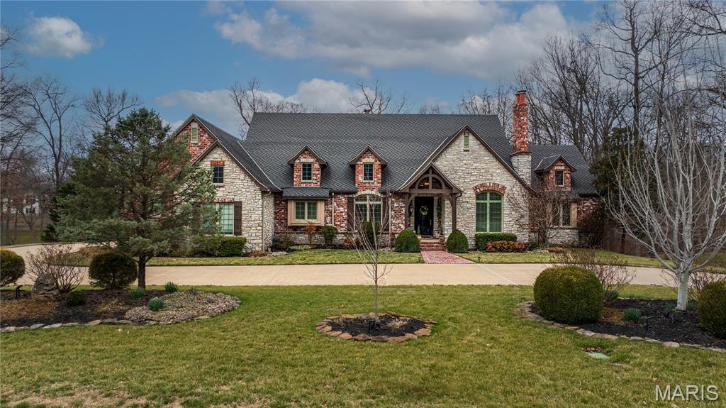 Never on the market before! Timeless French-inspired estate on 1.5 picturesque acres. From the outside to the inside you will see that nothing was missed. The home features travertine marble, slate, and hardwood flooring throughout while being filled with abundant natural light from all the rooms. The recently updated chef’s kitchen is highlighted by a 10 foot quartz island, Wolf range, double ovens, and Sub-Zero refrigerator & freezer. One of the most captivating spaces is the oversized breakfast room, featuring an elongated octagonal wood ceiling with restoration hardware lighting and views of the backyard, pool and peak of the lake. This custom home offers a perfect blend of cozy family spaces plus traditional formal spaces with dining room, large living room featuring a double sided fireplace with slate and decorative tile and corbels from Italy and a one-of-a-kind foyer entrance to the lower level. The expansive primary suite offers a sitting area with those beautiful private views, walk-in closet/dressing room with a built-in dresser & private washer and dryer. The ensuite bathroom is a true retreat with a jacuzzi tub and a whole-body rain shower. Main floor large office has vaulted ceilings, built-ins and is a perfect private work space or could be an additional main floor bedroom. The lower level lives like a main-floor space with soaring 10.5’ ceilings. Fabulous family room with custom mantel flanking the stone fireplace, a full bar, a game room and work-out space, an additional room specifically designed/wired as a theatre room, 3 additional large bedrooms and 2 full baths - WOW! If you aren’t sold already you will be with this back yard oasis! Perfectly designed landscape for privacy & entertaining or relaxing in style. Custom 20x40 gunite pool with built in lounge ledges, heater, auto cover all flanked by a flagstone patio and gas fire pits. Or relax under the pergola at the outdoor fireplace + plus still plenty of yard for the kids and pets to run and play. Lovely inviting screened porch, a circle drive with brick sidewalk and entryway with gas lanterns complete this home. A true distinguished and timeless home. *professional photos coming 2/23*