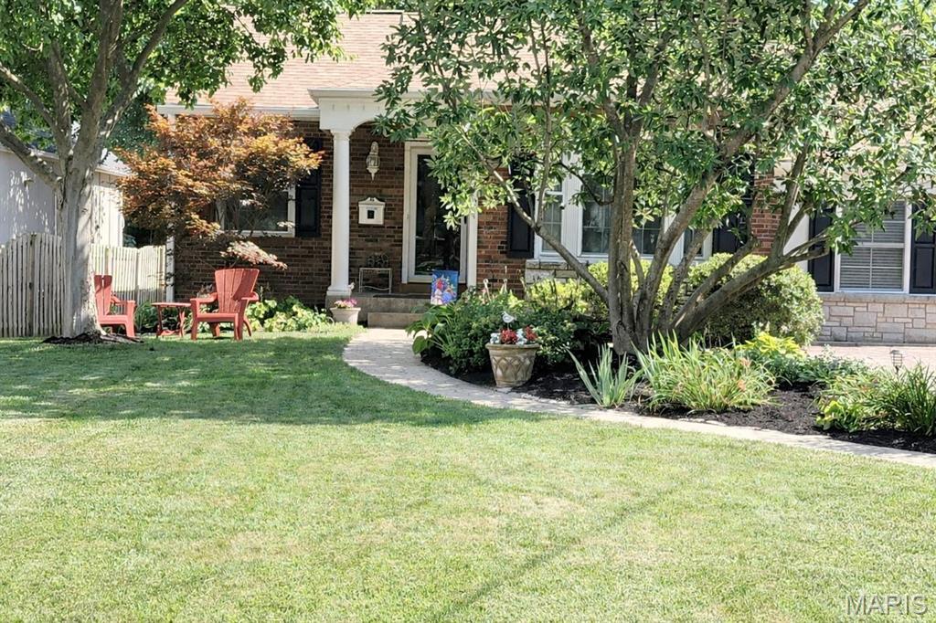 Storybook Kirkwood cottage in prime location in Jefferson/Argonne historic district  Expanded and updated with  a delightfully open floor plan, cathedral and coffered ceilings, wood floors, built-in bookcases, arched doors and decorative fireplace, and sunroom that opens to the maintenance free deck, large, private backyard and newer garage/carriage house! Main floor primary suite with private ensuite bath. lower level is partially finished. Enjoy Kirkwood at its best, walk to restaurants, shops and the Kirkwood Farmer's Market. Also enjoy the Kirkwood Community Center, pool and park.  Top rated Kirkwood School District! Photos in MLS 3/7, Showings begin Thursday 3/12,  Brand new roof being installed on house and garage 03/18-19
