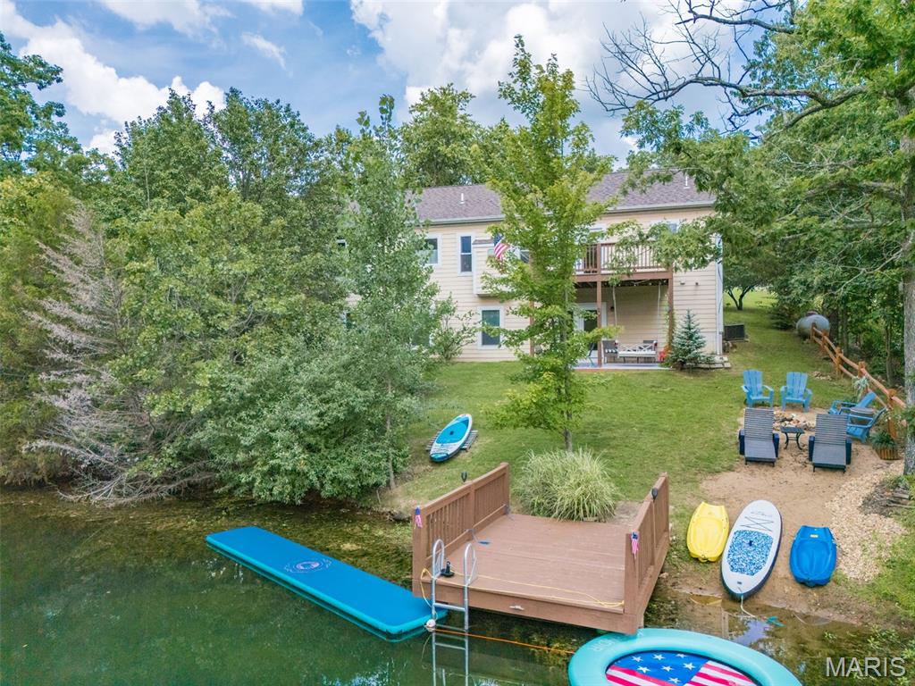 LAKEFRONT LIVING AT ITS BEST | Terre du Lac   Lake days. Sunset evenings. Memories that last a lifetime.
Tucked away in one of Terre du Lac’s most peaceful coves, this impeccably maintained lakefront retreat offers the perfect combination of relaxation, recreation, and investment potential.  Wake up to serene lake views, enjoy your morning coffee overlooking the water, then spend the day paddleboarding, swimming, fishing, or simply floating in the calm, crystal-clear cove. With a deep-water private dock, you’ll enjoy some of the best waterfront living Terre du Lac has to offer.  Designed for entertaining and hosting, this spacious home features 5 bedrooms, 3 full bathrooms, and the rare convenience of both upstairs and downstairs kitchens and living areas—ideal for large families, multi-generational living, weekend guests, or vacation long-term rental flexibility.  The private owner’s suite provides a peaceful escape, while the thoughtfully designed floor plan offers room for everyone to spread out and enjoy.   Whether you’re looking for your forever lake home, a luxurious weekend getaway, or an investment property that can begin generating income immediately, this home offers opportunities that rarely come available.  Basic turnkey and ready for you to just bring your clothes and enjoy the Lake Life.  Accepting all offers until Wednesday July 16th.