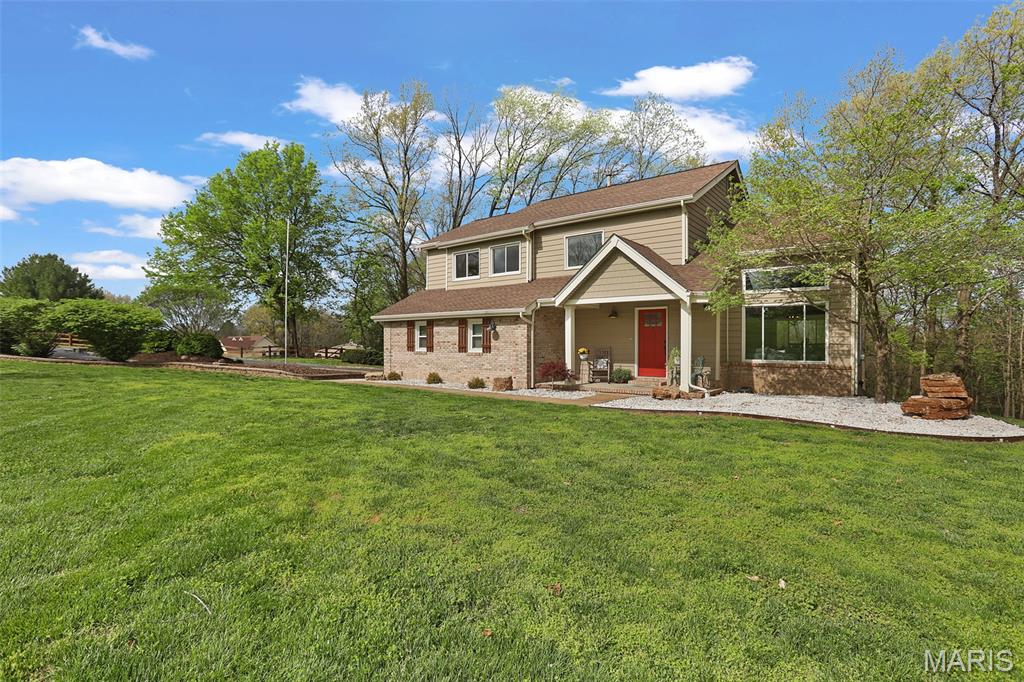 Welcome to your own slice of springtime paradise! Nestled on 3+ picturesque acres, this beautiful two-story home is surrounded by blooming trees, lush greenery, and breathtaking sunset views. The classic wooden fencing frames an expansive front yard, while the backyard backs to mature trees for the privacy and peaceful setting you’ve been dreaming of. A large outbuilding adds endless possibilities for hobbies, storage, or workspace, and evenings around the firepit will quickly become a favorite tradition. The newly stained deck is the perfect place to soak in the spring weather. Inside, the home offers an inviting and versatile layout with 3 bedrooms plus two additional flexible spaces-a loft area and a lower-level bonus room that can easily serve as extra bedrooms, an office, or hobby space. The hearth room with stone fireplace is warm and inviting as it opens seamlessly to the kitchen, featuring stainless steel appliances, a brand-new dishwasher, and granite countertops. The dining and living areas are bright and welcoming, highlighted by large windows that bring the beautiful outdoors in. The walk-out lower level expands your living space with a spacious family room, full bathroom, laundry room, plus the bonus room! Located in a charming small town with beloved local restaurants and nearby schools, this home offers the perfect balance of peaceful country living and everyday convenience. If you’ve been waiting for a home that feels like a retreat, this one is ready to welcome you home.