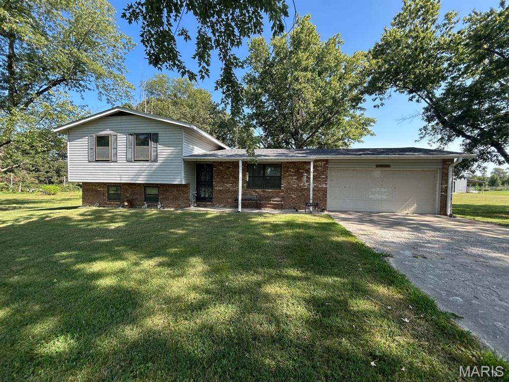 You have been asking for a home located out of city limits.  Here you go! Drive down the lane and you will immediately notice the inviting front-porch ready for you to sit and enjoy the wildlife. This 3-bedroom, 2-bathroom home sits on nearly an acre and ready for you to enjoy the peace and quiet of country life!  The main level has a living room, kitchen with a snack bar, dining area, and access to the two-car, attached garage and the covered, back porch where you can relax on the porch swing and enjoy a good book or just some quiet time!  The upstairs has 3 bedrooms and 2 bathrooms.  The basement has a family room with a fireplace, a storage closet, the laundry/mechanical room, and an office or possibly a small, 4th bedroom.  You have options, so call today to schedule your tour before it's too late!