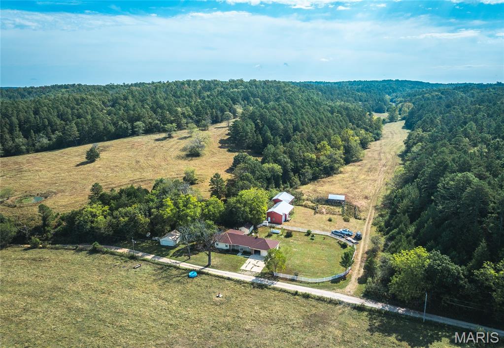 Located in the scenic hills of Southwest Missouri on the Texas and Dent County line, this exceptional 249 m/l acre farm offers the perfect blend of productive pasture, live water, and outdoor recreation. Just minutes from Montauk State Park, this property is ideal for those looking to run livestock, enjoy incredible hunting and fishing, or build their dream rural lifestyle. At the heart of the property lies a solid 3-bedroom, 2-bathroom home with an attached two-car garage, offering comfortable living space and modern conveniences. A large, well-maintained barn provides excellent storage for equipment and shelter for livestock. The crown jewel is over half a mile of Ashley Creek frontage, providing year-round water, scenic views, and fantastic recreational opportunities. This farm is a hunter’s paradise, with abundant deer and turkey populations, diverse terrain, and plenty of cover. The location near Montauk State Park also offers quick access to some of Missouri’s best trout fishing and additional outdoor recreation. Whether you’re looking for a working cattle operation, a hunting retreat, or a private escape in the Ozarks, this rare property offers it all—water, wildlife, and wide-open space.