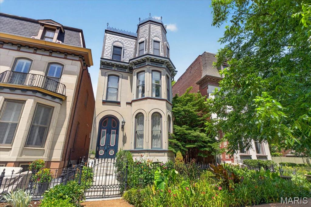 SHOWINGS WILL START THURSDAY (7/2). Available for the first time in 20 years, 2011 Park offers a rare chance to own a beautifully preserved 1885 Victorian Mansard roof home in Lafayette Square. Set directly across from Lafayette Park, this 5 bedroom, 3.5 bath residence with an office blends historic character with comfortable everyday living. Tall ceilings, abundant windows, and natural light create an inviting feel throughout. Period appropriate details honor its 19th-century roots, while thoughtful features add modern function. The kitchen enjoys a charming view of the scenic rooftop garden above the garage, a quiet retreat in the city. An oversized two-car full brick garage includes a lift for a third car, adding rare parking or storage flexibility. Solar panels on the house add an energy feature. Moments from neighborhood restaurants, shops, and Lafayette Park, this is a special opportunity in one of Saint Louis’ most treasured historic settings.