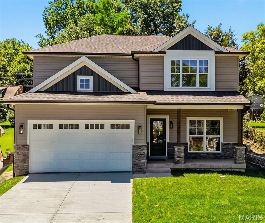 Exquisite custom new construction in the heart of Kirkwood, offering timeless design, elevated finishes, and exceptional craftsmanship throughout. This stunning two-story home features over 3,400 square feet of thoughtfully designed living space, including five bedrooms and 3.5 baths, ideal for both everyday living and elegant entertaining. A welcoming covered front porch opens to a light-filled interior highlighted by nine-foot ceilings on the main level, custom base molding, wainscoting, window casings, white french oak wide plank wood floors throughout the first and second-floor hallway and primary suite, a designer lighting package, and upgraded 3 panel doors with lever hardware. The open-concept floor plan flows seamlessly into the spacious family room with a 36-inch gas fireplace and stone surround, creating a warm and inviting focal point. The chef’s kitchen is a true showstopper, complete with upgraded 42-inch custom cabinetry with crown molding, quartz countertops, backsplash, soft-close drawers and doors, custom range hood, oversized center island with seating, breakfast bar, large pantry, and adjoining breakfast room. A custom mudroom with built-in cubbies adds everyday convenience, while the second-floor laundry offers custom shelving and functional design.
The luxurious primary suite is a private retreat, featuring tray ceilings, a spa-inspired bath with soaking tub, tiled glass-enclosed shower, adult-height dual vanities with individual mirrors, ceramic tile flooring, and closet with custom customized wood organization system . Four additional generously sized bedrooms offer double-deep closets, ceiling lighting, and are wired for ceiling fans. The finished lower level expands the living space with luxury vinyl plank flooring, a fifth bedroom with a private entrance to a full bath, and a drain system with sump pump and pit—perfect for guests, a private office, or multi-generational living. Additional highlights include high-efficiency zoned HVAC, 200-amp electrical service, hardwired smoke alarms, custom stair rail system, vaulted ceilings, covered rear patio with Hardy soffits and can lighting, and a two-car attached garage. A rare opportunity to own a meticulously built, custom home that blends modern luxury with the charm, walkability, and lifestyle Kirkwood is known for.