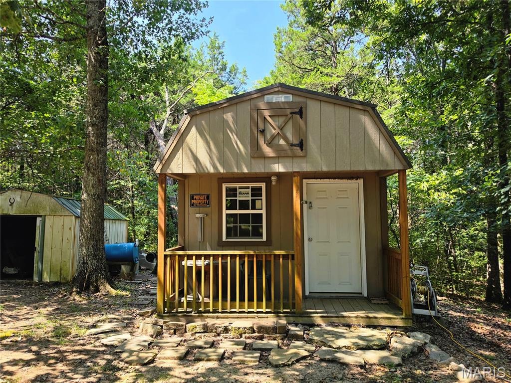 RECREATIONAL LAKE PROPERTY WITH THREE LOTS! Enjoy the best of outdoor recreation at Lonedell Lakes in Washington County, Missouri. This property includes three lots, meeting the lake restrictions for building a home, and offers access to three beautiful lakes, including a designated swimming area and excellent fishing opportunities.

A well-equipped 12' x 20' insulated building provides a comfortable place to enjoy weekends and getaways. The building features electric service, window A/C, propane heat with tank, refrigerator/freezer, futon, bunk bed, two standing cabinets, two tables, and a covered porch. The property also includes an additional storage shed, fire pit, two picnic tables, and a supply of cut firewood.

The property has 200-amp electric service, with the building capable of being connected to the electric pole. Included with the
sale are an electric log splitter, STIHL chainsaw, and 10-foot aluminum John boat, making this property ready for outdoor adventures from day one.

Whether you're looking for a weekend retreat, fishing and swimming getaway, camping spot, or a future homesite, this property offers plenty of possibilities. Water and septic are not currently installed and would be the buyer's responsibility. With three lots and the amenities already in place, this is a great opportunity to create your own recreational retreat at Lonedell Lakes!