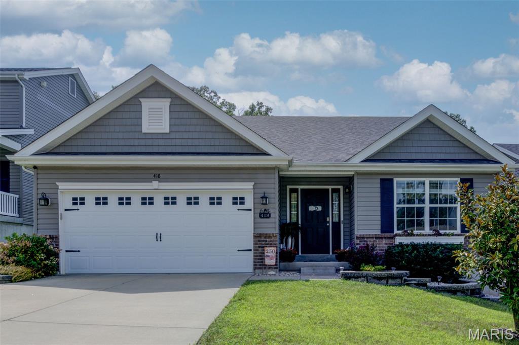 Welcome to 418 Dusty Brook Drive, where easy ranch-style living meets a bright, open layout made for everyday life and entertaining! Step inside to an airy main living space filled with natural light, vaulted ceilings and beautiful LVP flooring that flows throughout. The spacious Great Room features a decorative mantel that adds warmth and character, while the open Kitchen keeps everyone connected with granite countertops, crisp white cabinetry, stainless steel appliances, a pantry and a large breakfast bar perfect for morning coffee or gathering with friends. Just beyond, step outside onto the beautiful deck overlooking the backyard and tree-lined surroundings, an inviting spot to relax, grill or enjoy a quiet evening outdoors. The main level offers 3 bedrooms and 2 full baths, including a generously sized Primary Suite with its own private bath featuring a dual vanity. Main-floor laundry makes one-level living even more convenient! Downstairs, the walk-out basement is wide open and ready for whatever you can imagine: additional living space, a recreation room, home gym, office, guest space or a combination of it all. Walk directly out to the covered patio and backyard for even more outdoor living space. Complete with a 2-car garage, this home offers the space, functionality and open feel buyers are looking for, all wrapped into one beautiful ranch!