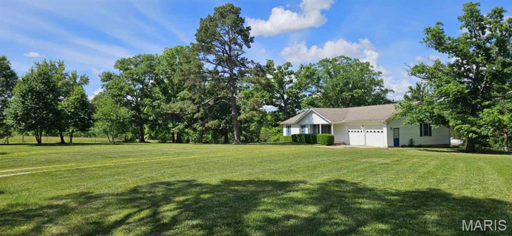 A once-in-a-lifetime opportunity awaits! This breathtaking 370 ACRES M/L is the ultimate Ozark retreat — where luxury living, recreation, ranching, hunting, and income potential all come together in one extraordinary property. Featuring TWO homes, a shop, hay barn, kennel, corrals, nine ponds, live water, three wells, marketable timber, and fenced pastureland, this property is built for the lifestyle you’ve dreamed about.  The beautifully maintained main residence offers 5 bedrooms, 3.5 baths, a full finished walk-out basement, attached 2-car garage, central heat & air with outdoor wood furnace backup, plus tasteful updates including windows, flooring, kitchen counters, sink, and appliances. A charming second home with 2 bedrooms, 1 bath, sunroom, newer roof, and central heat & air creates endless possibilities for guests, multigenerational living, rental income, or an Airbnb retreat.  Outdoorsmen and ranchers alike will appreciate the private rolling landscape of hills, valleys, woods, pasture, and scenic views. Hunt, ride horses or ATVs, run cattle, harvest timber, or simply enjoy unmatched peace and privacy. The timber has been lightly harvested with only approximately 20 acres timbered in the last 15 years, preserving the beauty and value of the land.  Additional amenities include a detached garage/shop with concrete floor, electric, water, and double garage doors on both ends, RV hookups with electric and water, auto-heated waterers, and a fully equipped kennel complete with water heater, sink, and AC units.  Located in rural Dent County less than 5 miles from Baptist Camp access on the Current River and just minutes from Montauk State Park, this remarkable property offers seclusion without sacrifice — approximately 2.5 hours from both St. Louis and Springfield.