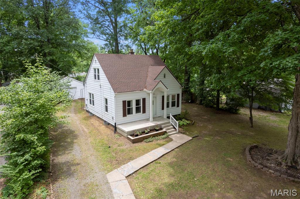 Incredibly charming and beautifully updated 3 bed 1 bath bungalow with thoughtful finishes throughout. The renovated kitchen features granite countertops and a gas range, while refinished light hardwood floors, an updated bathroom, and beautiful light fixtures add warmth and style. Outside, enjoy a large fenced yard with mature trees, a covered back patio, and a 2 car detached garage with plenty of room for parking and workspace.