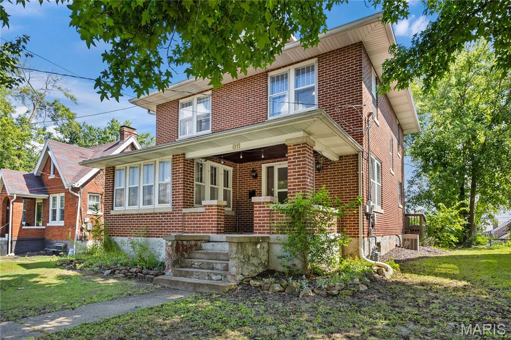 Step into historical charm with this gorgeous 2-story, 4-bed, 1.5 bath all-brick brownstone in the heart of the Jefferson City historic district. Character & charm abound in this solid, highly insulated home on a quiet street in a great family neighborhood. You will love the original hardwood floors throughout, solid wood doors, & updated electrical & lighting. There is plenty of room to grow with a spacious walk-up attic & a full unfinished basement! The main level boasts a large living room with fireplace & formal dining room featuring a beautiful wooden arched entry & tons of natural light. The kitchen offers tile floors, newer cabinets, & natural gas stovetop. A front sunroom serves as a perfect office or sitting area, while the covered front porch & spacious rear deck provide comfortable outdoor spaces. The front yard is beautifully landscaped with butterfly perennials on a level lot. Bonus: All appliances stay, including the washer, dryer, & water softener, & furniture is negotiable! Key updates have been meticulously completed while preserving history, including original interior windows paired with new exterior storm windows. Make your appointment to see it right now!