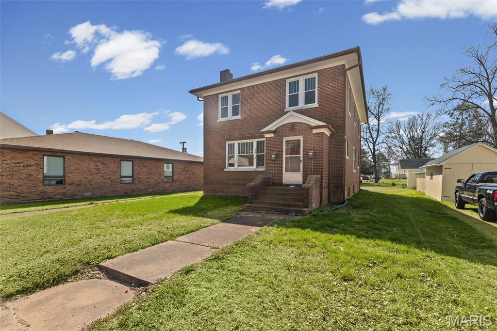 Located in the heart of Mascoutah, this property is full of opportunities. Currently zoned as 2-unit duplex, has previously been used as a single family residence. Live in one unit & earn income renting the other. This is a perfect addition to an investor portfolio. All brick with full unfinished basement. Main floor unit includes kitchen with appliances, dining room, Walk through bedroom, full bath, family room with fireplace & foyer entryway. Upper level (2nd unit) has 2 bedrooms, full bath, living room, bonus room and eat-in kitchen (appliances included). Laundry in basement. Parking area and large back yard is accessible from West State Street. Sold AS IS. Additional parcel #10-31.0-244-043. Lot dimensions: 57x100. Buyer to verify all information.