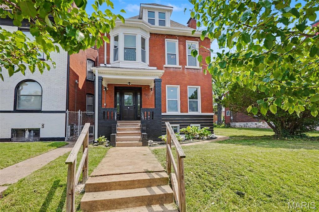 Welcome to 3911 Sullivan, where timeless historic character meets modern living in this beautifully renovated 3-story brick home, offering expansive, thoughtfully-designed living space + the rare bonus of an additional city lot included in the sale. With 5 spacious bedrooms, 2 full bathrooms, 2 half bathrooms, multiple living areas & flexible spaces designed for today's lifestyle, this home offers room to grow, entertain, work from home, or comfortably accommodate multi-generational living.
Upon entry, you will immediately appreciate the home's impressive scale, soaring ceilings, abundant natural light & original architectural details that give this home warmth & character. The foyer has a grand staircase with a beautiful backdrop of exposed brick. The inviting living room is anchored by a beautiful decorative fireplace & oversized windows, creating an ideal space for relaxing or gathering.
The spacious dining room easily accommodates dinner parties & everyday meals with an abundance of seating; it flows effortlessly into the updated kitchen. Designed with both function & entertaining in mind, the kitchen features abundant cabinetry all the way to the ceiling, generous counter space & an oversized breakfast bar that's perfect for casual dining, meal preparation, or hosting guests. The main level is rounded out by a beautifully renovated powder room.
The second floor offers three generously sized bedrooms & two full baths, including a spacious primary suite with its own private bathroom. Off the primary bathroom, you have your own private balcony where you can enjoy mornings & evenings overlooking the back yard. The finished third level adds two additional oversized bedrooms, creating exceptional flexibility for guest rooms, home offices, media rooms, playrooms, or creative studios. Whether you need room for a growing family or simply appreciate having options, this home adapts to your lifestyle.
The partially finished basement provides additional storage, utility space, workout space & a convenient half bath, giving you even more usable space beyond the home's already impressive footprint.
One of this property's most unique features is the included adjacent lot at 3907 Sullivan Avenue. Opportunities like this are becoming increasingly difficult to find in the city. Whether you envision expanding your outdoor living space, creating an incredible garden, adding a garage or carport with alley access, installing additional off-street parking, or simply enjoying the privacy of an oversized yard, the possibilities are endless.
Location is another standout feature. Situated just minutes from Downtown St. Louis, the new National Geospatial-Intelligence Agency (NGA) campus, Midtown, Saint Louis University, Barnes-Jewish Hospital, SSM Health, the Washington University Medical Campus & the Cortex Innovation District, this home offers convenient access to many of the region's largest employers while placing you near billions of dollars of continued investment & redevelopment.
Outdoor enthusiasts & gardeners will appreciate being just steps from the flourishing Sullivan Community Garden, where neighbors gather to grow fresh produce & build community. Nearby parks provide additional green space for recreation, while Forest Park, the Missouri Botanical Garden, City Museum, St. Louis Aquarium at Union Station, The Foundry, Grand Center Arts District &countless local restaurants, breweries & entertainment venues are all just a short drive away.
Homes offering this combination of historic charm, modern updates, generous square footage, flexible living space & an additional city lot are exceptionally rare. Whether you're searching for your forever home, need space for today's evolving lifestyle, wish to operate an income-generating short-, mid-, or long-term rental, or simply want exceptional value in the heart of St. Louis, 3911 Sullivan Avenue delivers the character, size & versatility you've been waiting for.