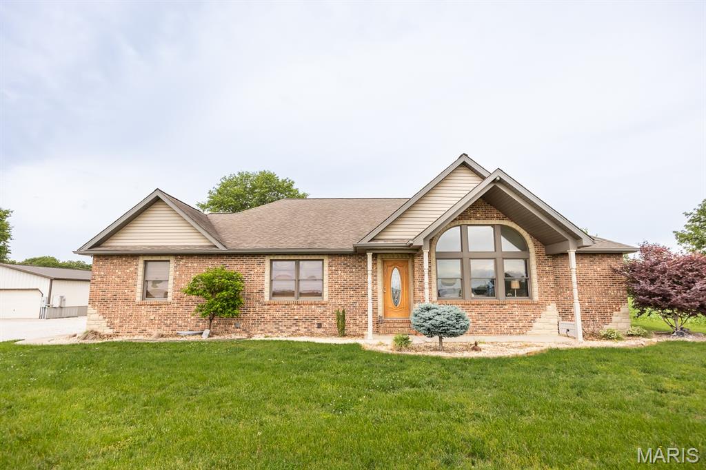 Set on 3 acres just outside Mascoutah city limits, this spacious ranch offers privacy, modern updates, and exceptional indoor–outdoor living. The living room features a gas fireplace, and the kitchen includes a breakfast bar, pantry, and generous counter space, opening to a large partially covered stamped-concrete patio. The primary bedroom offers walk-in closets and an en-suite bath with a tile walk-in shower and double vanity. Three additional bedrooms, a full bath, and a convenient 1/3 bath complete the main level, along with main-floor laundry. An open staircase leads to the lower level with a large family room and bar, game room, bonus room, and half bath—ideal for entertaining. Outside, enjoy a 40' x 60' metal outbuilding perfect for storage, hobbies, or equipment. Attached 2-car garage. Close to Scott Air Force Base. Buyers to verify all information.