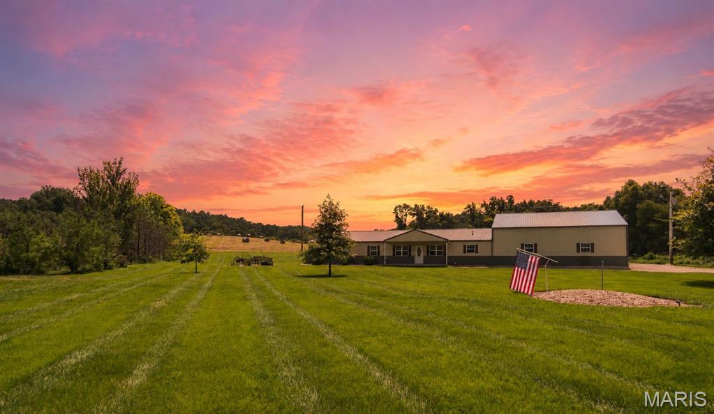 Country living has never looked better! Situated on 12 +/- beautiful acres, this one of a kind 2,100 sq. ft. shop house offers the perfect combination of comfort, functionality, and outdoor adventure.

Inside you'll find 3 bedrooms, 3 bathrooms, and an open floor plan designed for gathering with family and friends. The spacious primary suite features a walk-in closet and an oversized tiled shower, while the large pantry and laundry room make everyday living a breeze.

Whether you're a car enthusiast, woodworker, or simply need room to grow, the 40x40x12 climate controlled garage is ready for your next project. A additional 24x60x18 equipment shed provides plenty of additional storage for everything from campers and ATVs to farm equipment and hay.

Spend your evenings relaxing on the covered back porch overlooking the pasture, tend to the established garden, and enjoy the peace that only country living can provide. With spray foam insulation for energy efficiency and direct access to some of the area's best wildlife habitat by bordering Mingo National Wildlife Refuge and nearby Duck Creek conservation ground, this property truly has something for everyone.