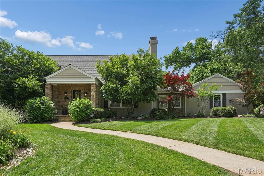 Meticulously clean, freshly painted, & updated 4-bedroom, 4-bath home in sought after Stoneleigh Towers. Located on a quiet lane in the Ladue School District, this home offers sun filled rooms, wood floors, a wood burning fireplace, an updated kitchen with gas cooktop & granite counters, a main level sunroom, & a large patio overlooking the private, level backyard with Missouri native perennial landscaping. Flexible layout includes 2 main level bedrooms plus a 2nd floor primary suite with dual closets, built-ins, en-suite bath with jetted tub, and an additional 4th bedroom. Finished lower level offers a wet bar, fireplace, half bath, & walk-up exterior access. Oversized 2 car garage with newer mid-century inspired garage door. This home will not disappoint!