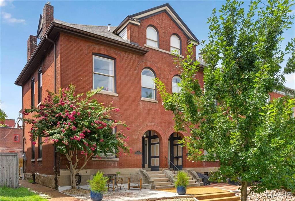 Style, sophistication, and roomy describes this beauty of a condo in Historic Lafayette Square. Located on friendly Dolman Street, you are just around the corner from the Lafayette Square neighborhood garden and are walking distance to a pet shop, bars, restaurants, and the plaza area. You will love this location! A lovely spacious patio in front greets you and it's the perfect spot to chat with neighbors enjoying a coffee or glass of wine. Inside you will love the stylish foyer and then the open floor plan. Large east facing windows flood the unit with light and the living room boasts a custom built-in bookcase, gas fireplace and is open to the dining area and kitchen, perfect for entertaining and today's lifestyle. The kitchen is beautiful with white cabinets and dark black granite and dark grey tile backsplash complementing all the stainless GE appliances. The sleek double ovens make holidays meals a snap. The first floor is complete with a roomy half bath with wainscotting and designer wallpaper. The lower level has custom woodwork paneled walls, cabinets and shelves with a large media area, a play area, and stylish wet bar! On the 2nd floor you will find two nice sized bedrooms, the laundry with front loaders, and a stunning full bath. Stylish brass fixtures and marble floors and bath surround give an elegant feel. The 3rd floor is entirely the primary bedroom, nice and cool with it's own split HVAC system, there is a desk area, sitting area, built-in book shelves and soaring dramatic ceiling lines. The European large standing glass shower with marble base and exposed brick is super cool and the bath is spacious. With a low condo fee, a terrific street location convenient to everywhere, and a chic interior, this is Lafayette Square living!