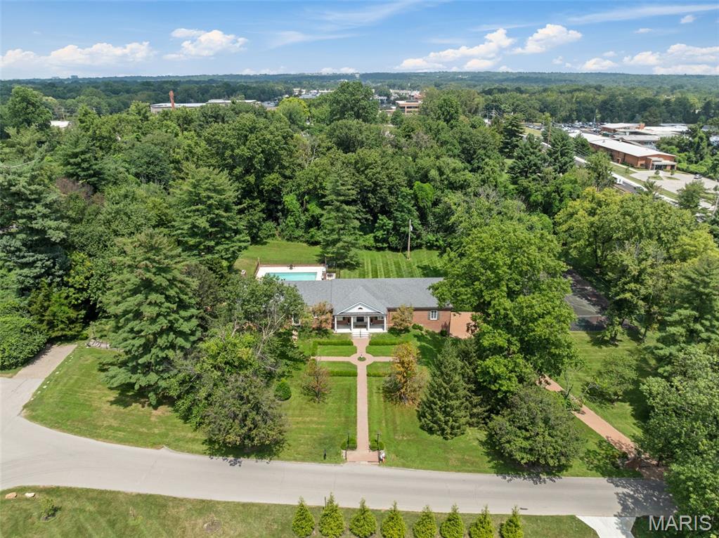 Set in the prestigious Huntleigh Woods neighborhood, this stately 5-bedroom, 4.5-bath Greek Revival ranch offers a rare blend of elegance, privacy, and potential. Resting on 2.23 beautifully landscaped acres, the home features gracious proportions, classic architectural details, and a timeless presence.
From the moment you enter, you're welcomed by traditional charm—rich millwork, hardwood floors, custom built-ins, and multiple fireplaces lend character throughout the formal living and dining rooms, spacious kitchen and light-filled family room. French doors open to a private backyard retreat with an in-ground pool, manicured gardens, and expansive patio.
• Gracious entry hall with classic detailing
•  Formal living room and sitting room
• Vaulted family room with fireplace and French doors
• Formal dining room with fireplace
• Kitchen with breakfast bar and eat-in area
• Spacious primary suite with en-suite bath
• Expansive lower level and abundant storage
• Attached 3-car garage
This home offers an incredible opportunity to renovate or reimagine the space to suit your personal style, with generous square footage and a strong architectural foundation already in place.
With its unparalleled location, refined character, and unlimited potential, this is a rare chance to create a truly one-of-a-kind residence in one of the area’s most distinguished communities.
Shown by private appointment only.