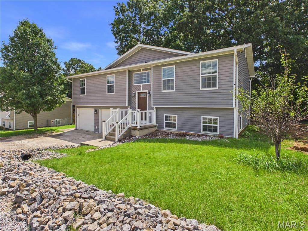 This beautifully finished 4-bedroom, 3-bathroom split-foyer home at 177 Antler Trail offers comfort, privacy, and convenience just minutes outside of Poplar Bluff. With 2,158 square feet of living space, the layout provides separate living areas ideal for those who value both togetherness and personal retreat. The custom high-end kitchen is designed for both everyday enjoyment and hosting memorable gatherings, while the private suite features a full, exceptionally comfortable bathroom. Recessed lighting adds a modern touch throughout the home, and the private back deck offers a peaceful escape overlooking a serene, natural setting. This property blends convenience with tranquility, making it a wonderful place to call home.