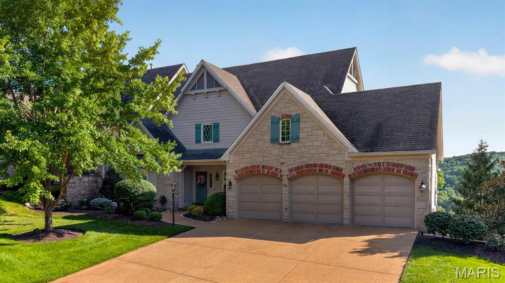 Perched high above the rolling hills of prestigious St. Albans, this extraordinary villa commands some of the most breathtaking panoramic views in the region. Overlooking lush fairways, wooded valleys, and miles of protected natural beauty, the setting is nothing short of spectacular. Combined with timeless architecture, exceptional craftsmanship, and luxurious finishes throughout, this is a home designed to impress while offering the comfort of everyday living. A dramatic two-story great room welcomes you with soaring beamed ceilings, a floor-to-ceiling stone fireplace, rich hardwood flooring, custom built-ins, and an entire wall of windows that frame the magnificent landscape beyond. Bathed in natural light, the open-concept design creates a seamless connection between the living spaces while allowing the remarkable views to take center stage. The gourmet kitchen is a true showpiece, thoughtfully appointed with custom cabinetry, granite countertops, Sub-Zero refrigeration, professional-grade stainless steel appliances, double ovens, a gas cooktop, and spacious pantry. Flowing effortlessly into the adjoining breakfast room, every space has been designed for both elegant entertaining and comfortable everyday living. Just beyond, the inviting hearth room offers a second stone fireplace and direct access to the expansive deck, creating the perfect place to enjoy morning coffee, evening sunsets, or gatherings with family and friends. Stretching across the back of the home, the outdoor living space offers multiple seating areas and uninterrupted views that change beautifully with every season. The main-level primary suite is a private retreat featuring a spacious sitting area, dual walk-in closets, and an exceptional spa-inspired bath complete with dual vanities, extensive custom cabinetry, and oversized walk-in steam shower. Every detail has been thoughtfully designed to create a peaceful escape at the end of the day. The upper level offers a spacious secondary suite complete with a large walk-in closet and private bath, while the finished lower level dramatically expands the home’s living space. Here you'll find a large recreation room with herringbone flooring, custom wet bar, Sub-Zero beverage refrigerator, dishwasher, granite countertops, gas fireplace, and walkout access to the covered patio. An additional bedroom and full bath provide comfortable accommodations for guests. The thoughtfully designed floor plan also includes a beautifully finished main floor laundry room, elegant powder room, extensive custom millwork, plantation shutters, designer lighting, built-in cabinetry, and exceptional storage. Outdoor living is equally impressive. The spectacular two-story Tigerwood deck, complete with rail lighting, ceiling fans, retractable shade system, and sweeping golf course views, creates an unforgettable setting.
Additional highlights include an oversized three-car garage, whole-house generator (2025), irrigation system maintained by the HOA, dual-zoned HVAC, Hardie Board siding, landscape lighting, and numerous major system updates. Perfectly positioned within one of St. Louis’ most exclusive golf communities, residents enjoy world-class amenities, championship golf, tennis, club dining, scenic walking trails, and an unmatched lifestyle surrounded by natural beauty.
Offering exceptional views, luxurious finishes, and the low-maintenance lifestyle buyers are searching for, this remarkable St. Albans villa is a rare opportunity to enjoy resort-style living in one of the area's premier communities.