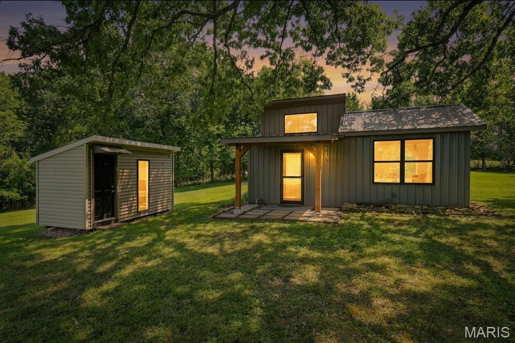 This property is stunning! Breathtaking views, beautifully flat, 2 ponds, access to Big River, Primrose Creek runs through the property, and so much more! 344 square feet of cabin living space. Connected to a septic system and a well (replaced 15 years ago per owner) Main house has an eat in kitchen all stainless steel appliances shown stay. Main living space is beautifully updated with lots of natural wood accents, updated cabinets, a double bowl kitchen sink, and sliding barn doors. Bathroom has a stand up shower. Bedroom has vaulted & beamed ceilings. Right next door to the cabin is an ADU unit. Currently does not have the wall unit in place but was once used as an additional sleeping space. Cabin has metal siding and roof. Hot water heater is 4 years old and dielectric unions were replaced last year. Fire pit and bench stay. Right next to the fire pit is a place for an RV with electric and sewer hook up. Down through your massive cleared front yard you'll see a 20x14 workshop area attached to a 24x14 2-car garage. Building is all wired however electricity is not currently ran out to it. The owners brush hog the 3 fields on the property twice a year. There is a path around the property cleared. There is a walking path to both big river and primrose creek near the end of the 3rd field. The large pond is located near the 3rd field as well. The pebble creek with rock bluffs is just beautiful! Gravel road takes you through your road easement to the gate of your property. So many potential uses for this property bring your dreams and check out this canvas!