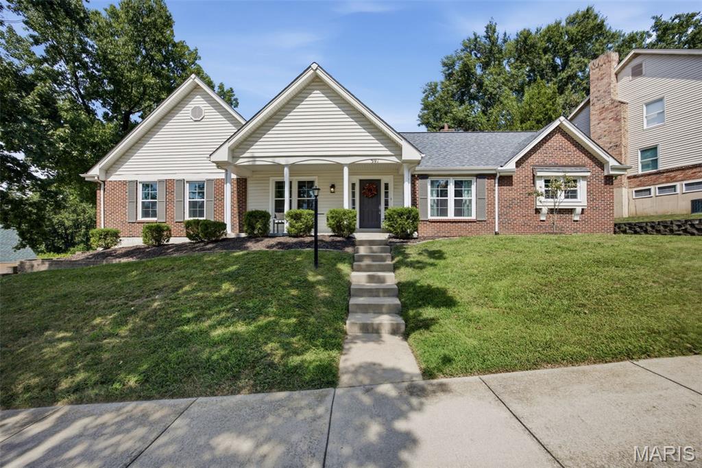 Some homes check the boxes. This one leaves an impression. From the inviting covered front porch to the soaring vaulted ceilings inside, every space feels open, comfortable, and ready to be enjoyed. White oak engineered flooring, updated lighting, and insulated windows carry throughout the main living areas. Just off the entry, a versatile bonus room makes an ideal home office, den, or could easily be enclosed as a fourth bedroom. A dedicated dining room is ready for everything from holiday dinners to everyday gatherings. The dramatic floor-to-ceiling brick see-through fireplace anchors both the vaulted living room and family room, creating one unforgettable living space. Just beyond, the oversized screened deck feels like an extension of the home—a place you'll look forward to enjoying from your first cup of coffee to peaceful evenings at the end of the day. The kitchen opens seamlessly to the living room and features granite countertops, stainless steel appliances, a breakfast bar, pantry, and tile backsplash. The spacious owner's suite offers room for a sitting area, while the ensuite bath features a soaking tub, separate shower, dual vanities, and a skylight. Two additional bedrooms, an updated hall bath, and main-floor laundry complete the main level. And if you've been searching for more garage space, you've found it! The six-car tandem garage is an opportunity that's rarely available, offering incredible flexibility for vehicles, storage, hobbies, or a workshop. An updated electrical panel (2026) is another welcome bonus, all within the desirable Parkway School District.