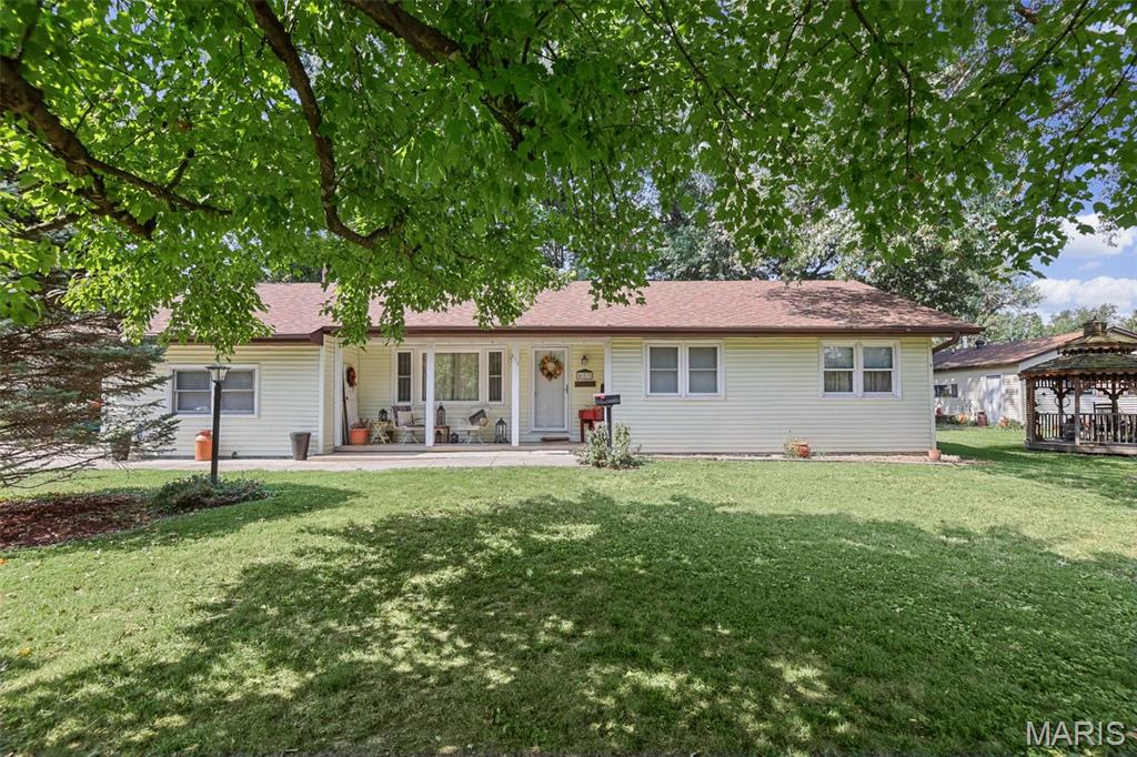 Move-in ready with plenty of charm and a little bit of country right in town! The inviting front porch and flower-filled landscaping set the tone before you even step inside. This home offers 2 bedrooms, 1.5 baths and a spacious family room/Bounus Room that could easily be converted to a 3rd bedroom. The family room has been updated with red cedar plank walls and features a wood-burning fireplace that was cleaned and serviced last fall. You'll also find cedar accents on the back porch, where additional washer and dryer hookups are hidden behind the planks if you'd prefer to relocate the laundry.
Kitchen appliances stay, along with the new stackable washer and dryer. Outside may be where this property really surprises you! The backyard backs up to the park and features a new red cedar pergola, gazebo, carport and storage sheds. Deer and turkey are frequent visitors, giving the backyard a peaceful, country feel.
The insulated 2-car garage is heated with propane, has its own electric meter and includes a half bath. An additional room provides even more possibilities—home office, salon, hobby room or whatever fits your needs.
Lots of character, flexible living space and room to enjoy both indoors and out!
Outhouse does not stay with the property.