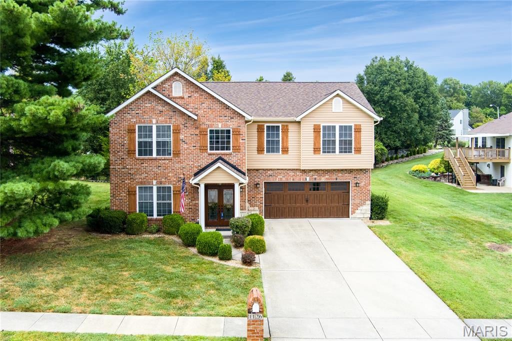 Ideally located less than a mile from the park, dog park, walking trails, and YMCA—and only a mile from O’Fallon’s vibrant downtown.

This beautifully updated 4-bedroom raised ranch offers thoughtful design, modern comfort, and exceptional craftsmanship throughout. Cathedral ceilings, granite countertops, and six-panel wood doors add warmth and character, while the main bedroom features spacious his-and-her closets. Additional highlights include a luxury bath, a tray-ceiling family room with a cozy fireplace, an impressive 20 x 35 garage, and a generously sized lot.

The kitchen, remodeled in 2026, showcases stunning custom cabinetry, custom stainless-steel appliances, a double-drawer dishwasher, and a built-in toekick vacuum. Every cabinet was crafted with purposeful storage in mind, ensuring a place for everything you use and love. The beautifully sized granite island features a discreet pop-up charging station and two built-in outlets, blending beauty with everyday convenience—every detail thoughtfully designed to create a space that is both elegant and highly functional.

The upstairs bathroom, updated in 2025, offers a relaxing soaking tub, a modern vanity with convenient in-vanity plug-ins, and a spacious shower with dual shower heads. The downstairs bathroom, renovated in 2024, mirrors this comfort with a beautiful wood vanity and another dual-head shower. Together, these spaces reflect intentional design focused on ease, comfort, and everyday luxury.

New carpet installed in 2026 enhances the home’s fresh, move-in-ready feel.

Major updates include: roof (2025), siding/gutters/gutter guards/shutters (2026), garage door and opener (2025), front door (2023), sliding glass door (2025), upstairs flooring (2026), downstairs flooring (2022), AC/HVAC (2022) with digital Wi-Fi thermostat, water heater (2019), vents cleaned (2026), and electric panel (2006). Deck stairs replaced 2026.  With modern finishes and extensive improvements already completed, this home offers peace of mind and effortless living.  Please do not touch pool table.  Pool table not for sale.  
Listing agent related to seller