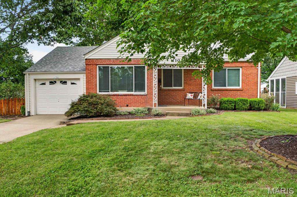 Picturesque ranch on a beautiful corner lot in one of Webster Groves' favorite streets! This 3-bedroom 1 bathroom home features over 1,500 sq ft of living space, bright windows, updated kitchen and bathroom, hardwood flooring and a simply stunning fenced lot. The open floorplan living room and dining room area is spacious, with large windows overlooking the covered front porch. The sparkling kitchen includes glass block windows, newer stainless refrigerator, granite countertops and a breakfast bar. The primary bedroom boasts 2 closet and large windows, with a second main level bedroom nearby. The full bathroom includes newer vanity, flooring and glass block windows. Downstairs, a third bedroom features a large walk-in closet and egress window. The large rec room has a 7' ceiling and is perfect for entertaining, office, workout or playroom. And the yard is a true show-stopper, with a cool, covered porch, newer concrete patio and gorgeous, level fenced backyard. An oversized one-car garage adds convenience. With Webster Park, shops and restaurants nearby, this lovely home in the Groves School District is a winner!