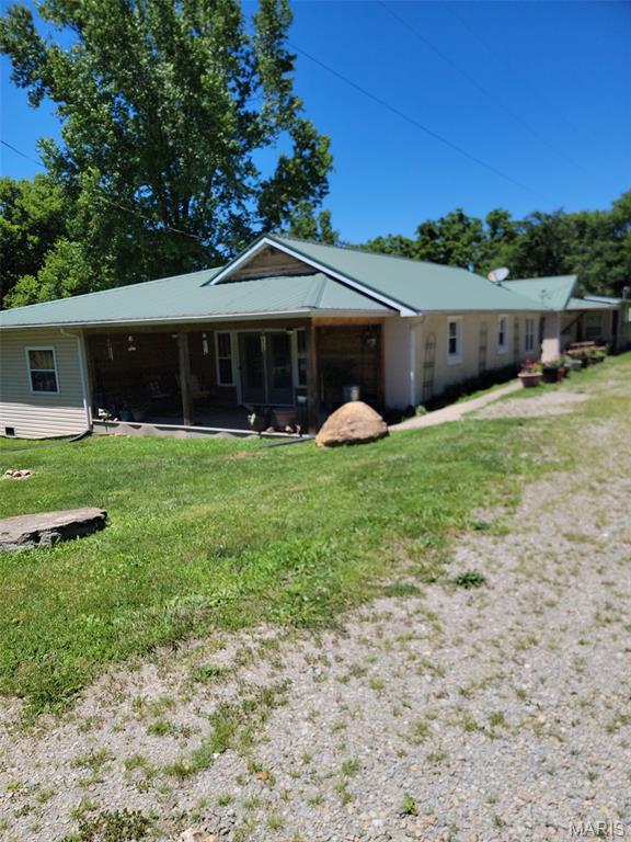 Escape to the beauty of country living with this riverfront property offering approximately 5 acres and over 2,200 sq ft of living space! Nestled along the scenic Big River and Mill Creek, this unique 2-bedroom, 2-bath home provides the perfect blend of privacy, natural beauty, and everyday comfort. Enjoy peaceful mornings on the covered front porch, evenings by the water, and breathtaking views year-round.  Inside, you'll find spacious living areas with hardwood flooring, a large custom kitchen designed for gathering and entertaining, and a generously sized primary suite featuring a walk-in shower. Two large living rooms provide plenty of space for hosting family and friends or simply relaxing after a day outdoors. Oversized garage with additional covered parking offers ample room for vehicles, equipment, and recreational toys. Public water and sewer provide the convenience of modern amenities while maintaining the charm of a rural setting.  Whether you're looking for a full-time residence, a weekend getaway, or a peaceful retreat surrounded by nature, this property delivers. Plus, the home is located in a USDA-eligible area, presenting a fantastic financing opportunity for qualified buyers. Don't miss your chance to own this one-of-a-kind waterfront property with acreage, privacy, and endless possibilities!