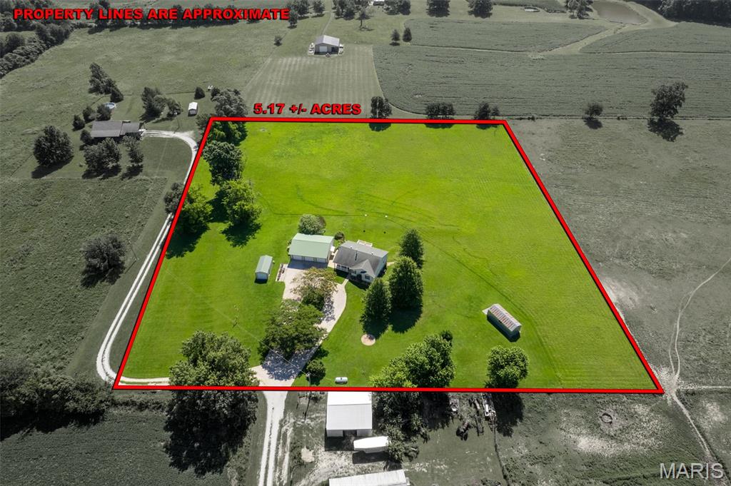 OH, THAT COUNTRY FEELING! If you have been searching for your slice of heaven in a peaceful, picturesque rural setting, this 5 acre gem of a property says your search is over * * Impeccable & Charming 3+ Bedroom, 3 Bath home offering approx 2,172 finished SF * Custom oak flooring most of main floor * Open floor plan Living Rm / Dining Area / Kitchen * A chef’s dream of a kitchen with granite counter tops & center island/breakfast bar * Primary Ensuite * Main floor laundry * Free-standing woodburning stove * Step out onto the maintenance free deck and take in the pastoral vistas * Family living and entertaining continue in the walkout finished lower level that includes: a spacious family room/workshop with window - part of which could be converted into a future 4th Bedroom ; Full Bath ; Rec Room ; Safe Room & plenty of storage * Whole House Generator * Circle Drive to house * 3 outbuildings .... 30 x 40 insulated 3 car detached garage just steps from the house (with 220 for welding) * 12 x 24 metal shed * Portable 10 x 20 storage shed * Manicured lawn &
flowers * Low utilities thanks to an efficient heat pump (Budget Billing $158/mo) * Stake your claim today!