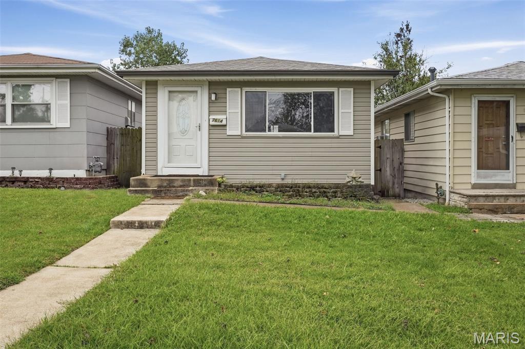 Affordable & sweet bungalow tucked away on a quiet street! You practically have to know the secret handshake to find this cozy little gem. With a manageable size and surprisingly generous living space, this home is easy to maintain without sacrificing comfort. The spacious living room features beautiful original hardwood floors, while the bright & cheery kitchen offers plenty of cabinet and countertop space. Two bedrooms and a full bath complete the main level. Head downstairs to find even more room to spread out, including a large family room, half bath, spacious laundry room, and versatile bonus room—perfect for a home office, gym, hobby room, or guest sleeping area. Outside, enjoy a good-sized fenced backyard with a concrete patio and an awesome 2-car garage—a rare and valuable bonus. New A/C in 2026. Charming, comfortable, and easy to care for, this cozy home is ready for you to unpack, settle in, and relax!