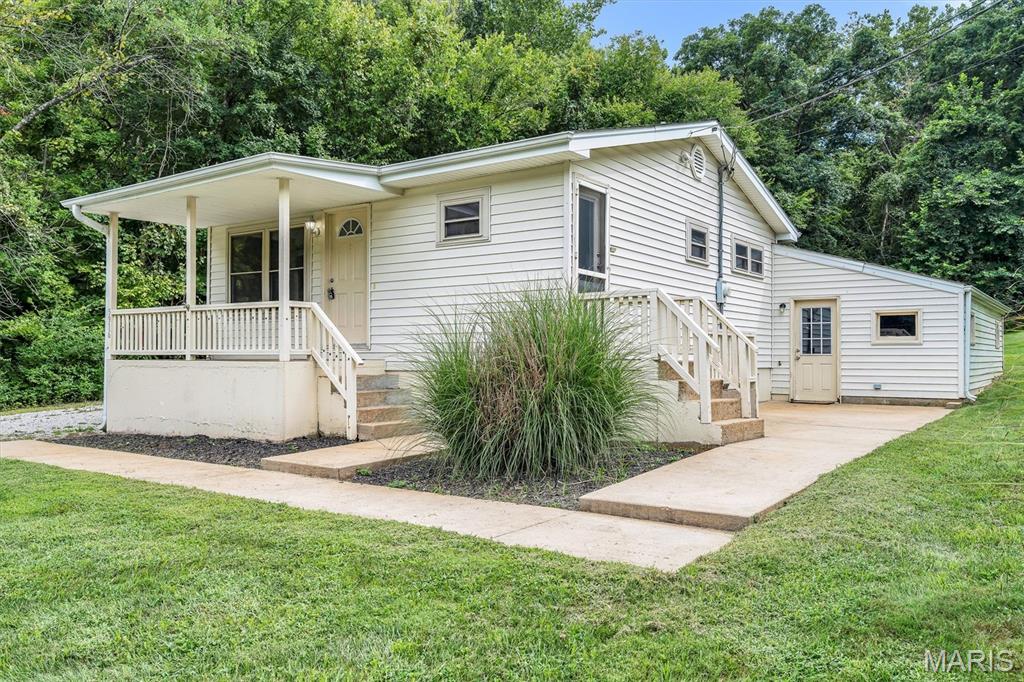 Don't let this one slip by you again! Come check out this great house on an amazing lot! If privacy is what you want, this is the one. As you pull up, you'll notice all of the great parking space in addition to the two-car garage. If you have a work vehicle or need extra parking for your toys, this is perfect. Inside you'll notice the hardwood floor, neutral paint colors, and white kitchen cabinets. The open floor plan gives this house a great layout for entertaining. Two bedrooms on the main floor as well as an updated bathroom. The lower level is finished off to provide a great living room, office space, an additional half bath, and a laundry room. The walk out basement is a plus for moving bigger items in or out. The attached two car garage could also serve as a great workshop. With close to a half-acre lot, you're nice and spread out from the neighbors. Being surrounded by mature trees, it feels like your own private wooded retreat. Hurry up and come check it out!