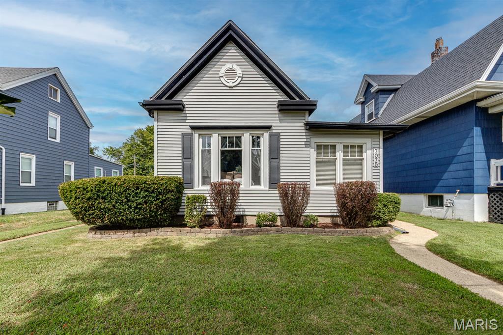 Historic charm meets modern city living in this beautifully maintained 1913 Victorian farmhouse in the Lindenwood Park neighborhood. Original trim, doors, hardware, tall ceilings, and a classic foyer fireplace showcase the character of this distinctive home, while an updated kitchen and bathroom provide modern convenience.

Two spacious main-floor bedrooms are complemented by a versatile third bedroom in the upper level, that has been enjoyed as a home office, movie room, and guest space. Hardwood floors were added in 2022, and a new roof installed in 2026 adds peace of mind.

Outside, enjoy a fenced yard with low-maintainence landscaping and a large patio, plus a detached two-car garage with alley access. The full basement provides additional living space, laundry, and ample storage.

Located near Lindenwood Park, Ted Drewes, Donut Drive-In, two city libraries, neighborhood restaurants and businesses, and convenient highway access, this home offers the best of historic St. Louis character and an easy, connected life style.