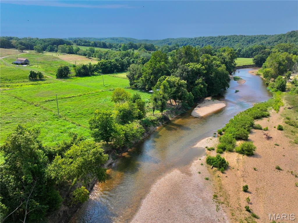 Just 3.5 miles downstream from Bennett Spring State Park, this exceptional 4 acre Niangua River property offers a rare opportunity to own a premium stretch of one of Missouri’s most sought-after trout fisheries. Whether you’re looking for the perfect weekend retreat, a future homesite, or an investment in riverfront land, this property checks every box. Featuring 193+/- feet of private Niangua River frontage, you’ll enjoy outstanding trout fishing, relaxing float trips, kayaking, swimming, and unforgettable evenings along the water’s edge.

The property offers level, buildable acreage outside the floodplain, providing an ideal location for your dream cabin or forever home while maintaining easy access to the river. With electric ran to both the top half along the road and the bottom half along the river. Just choose where you want to have your meter placed for quick easy setup. 

Towering hardwoods provide shade and privacy while the open river bottom creates beautiful views of the surrounding countryside. Located in an area renowned for trophy rainbow and brown trout, smallmouth bass, and goggle-eye fishing, this property is an outdoor enthusiast’s dream. The nearby Bennett Spring trout fishery attracts anglers from across the country, while the Niangua’s gentle current makes it equally popular for canoeing, kayaking, and floating with family and friends.

Properties with private river frontage this close to Bennett Spring are becoming increasingly difficult to find. Whether you’re searching for a recreational getaway, future retirement property, or a place to create lasting memories on one of Missouri’s most iconic rivers, this property is ready for you to enjoy from the moment you arrive.