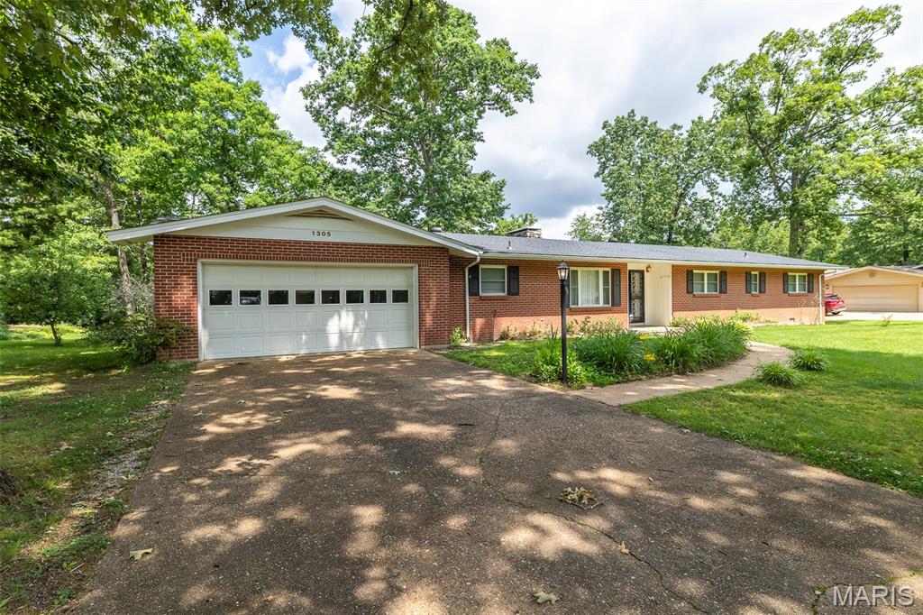 $294,500. 1305 Lurlyn Road. Set in the desirable Haven Hills subdivision, this 3-bedroom, 2-bath brick home with an attached 2- car garage sits on a spacious 0.48-acre lot and offers a strong combination of updates and functionality, timeless character, and lasting quality.
Beautifully-preserved original oak hardwood floors showcase the home’s enduring craftsmanship. The family room features an inviting gas masonry fireplace, creating a warm and comfortable gathering space ideal for relaxing evenings or entertaining guests.
The kitchen features durable Cambria Quartz countertops, and brand-new appliances with a refrigerator, oven, microwave, and dishwasher. A new washer and dryer are also included. 
Out back, a concrete patio extends your living space outdoors, offering area for seating, grilling, or entertaining while overlooking the generous yard. You'll also find a rear storage room that is ideal for lawnmower parking and extra storage. 
With a spacious yard to enjoy, quiet roads perfect for evening walks, and a convenient central location close to the amenities of town, this home offers the ideal blend of comfort, convenience, and neighborhood charm — creating a warm and inviting place for family and friends to gather for years to come.

1960 construction date is considered approximate.