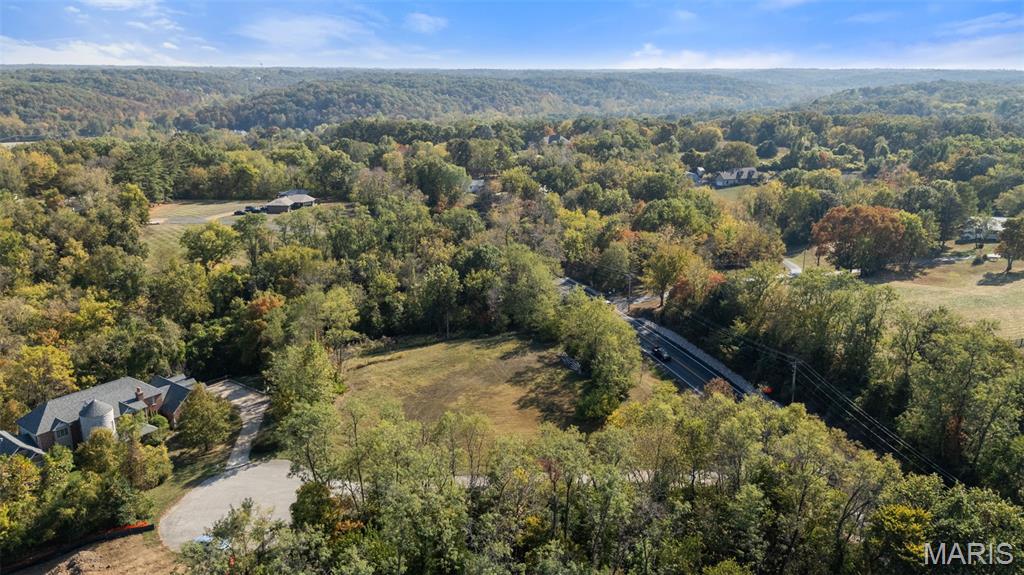 Exceptional Custom Home Opportunity in Wildwood. Build your dream home on this premier 3-acre lot in one of Wildwood’s most desirable areas—a quiet enclave of just three custom home sites. In an area that supports luxury residences valued at $1.5M+, this beautiful cul-de-sac lot offers the perfect setting for your custom dream home in a friendly, luxurious community of distinctive residences. The primarily level lot can easily accommodate a spacious, estate-style residence, with architectural flexibility to bring your own vision to life. Existing plans by William D. Cover, AIA, a respected St. Louis architect known for timeless designs that harmonize with their natural surroundings, are available separately—offering a sophisticated starting point if desired. The current plans are for a 3800 square foot home but there is plenty of room and design flexiblity for a larger home. Here, refined rural living meets exceptional convenience—just minutes from the Spirit of St. Louis Airport, Chesterfield Valley’s shops and restaurants, and abundant recreation. With electric service already on-site (well and septic needed), no subdivision builder restriction, and enhanced access via the new roundabout and proximity to 64/40, this is a rare combination of privacy, convenience, and prestige.