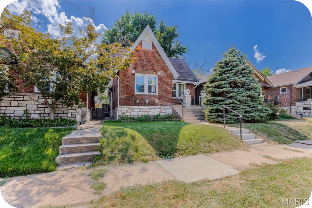 Gingerbread charm with a side of "you're going to love living here." 3820 Burgen is full of character and ready for its next chapter! Note the enchanting exterior as you enter into your living and dining rooms. No cookie cutter facade here! Check out the updated flooring and light fixtures along with a decorative fireplace as a focal point. Next up, the kitchen brings a lovely mix of retro and updates  with durable and bright metal cabinets and granite countertops. Plenty of storage abounds here for your all your culinary needs! Rounding out the floor are two good-sized bedrooms and a sharp updated bathroom. Downstairs, an unfinished basement provides plenty of storage along with a SUMP PUMP that was installed in 2020 (a rare find in South City!). Step outside onto the refinished newer deck and enjoy the cool shelter provided by your big shade tree-perfect for morning coffee or entertaining friends. A one-car garage adds convenient off-street parking. Several recent improvements have been made including a new tankless water heater (2024),  new gutters and gutter guards (2021), all new basement windows (2024) and a new deck added on also in 2024. And the location? Let's talk for a minute about the highly sought-after neighborhood vibe that is Holly Hills.  This is the type of place where neighbors make it a point to get to know each other! And it's walking distance to Carondelet Park (where you can feed the geese and listen to outdoor concerts in the summer), St. Stephen of Protomartyr school and the convenience of Hwy 55 minutes away! In addition, this neighborhood is famously busy with trick-or-treaters on Halloween so snatch this one up fast and move in just in time to use that front porch!