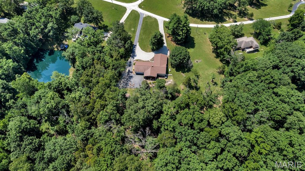 This is the setup everyone keeps asking for and almost never finds. 8 Oakwood Estate is a 3-bedroom, 3-bath ranch on 3.01 private wooded acres with an attached in-law suite that gives this home serious flexibility. Need space for extended family, long-term guests, a private office, hobby space, or separate living quarters? This one actually has it.
The main home feels warm, open, and easy to live in with newer flooring, multiple gathering spaces, a formal living room, formal dining room, and a great room with fireplace that walks out to the 25x12 covered deck. The updated kitchen is ready for real entertaining with a large center island, generous cabinetry, and a baker’s-style working pantry with counter space, shelving, and organized storage.
The attached suite offers its own living/dining area, kitchenette, bedroom space, walk-in closet, bath access, and private exterior entry — connected when you want it, separate when you need it. Outside, enjoy wooded views, mature trees, a circular driveway, shed/outbuilding, and an oversized rear-entry garage.
Private acreage, ranch living, outdoor living, updated kitchen, working pantry, in-law suite, flexible space, oversized garage, newer flooring, newer roof, and newer water heater — 8 Oakwood Estate checks a lot of hard-to-find boxes.