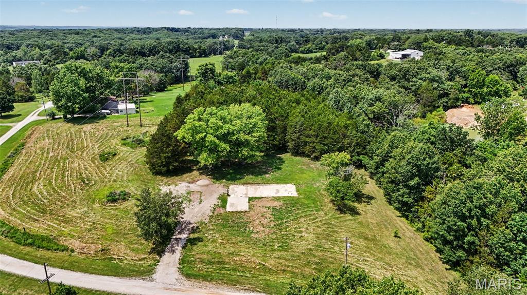 Build your dream home, place a mobile home, or invest in nearly 3 acres of unrestricted land in the highly sought-after Wentzville School District. This 3.11-acre property offers the perfect blend of cleared and wooded ground, providing both privacy and a ready-to-build homesite. Electric and public water are available at the property, making it even easier to bring your vision to life. Existing improvements include a concrete pad and gravel driveway, adding value and convenience from day one. Whether you're looking for a peaceful homesite, room to expand, or an investment opportunity with no subdivision restrictions, this versatile property offers endless possibilities. Don't miss your chance to own this beautiful piece of land in a fantastic location!