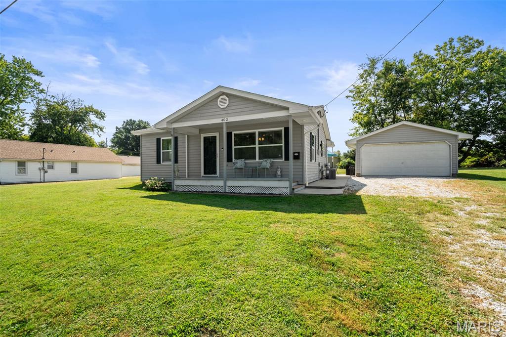 Some homes are updated. Others are truly cared for—and you can feel the difference the moment you walk through the door. Tucked away on nearly a quarter-acre right in the heart of town, this meticulously maintained 2-bedroom home offers a rare combination of privacy, peace and quiet, and the convenience of being close to everything. Pride of ownership shines throughout, with nearly every detail thoughtfully updated, including flooring, electrical, plumbing, lighting, kitchen cabinetry and countertops, a beautifully remodeled bathroom, newer siding and windows, plus a newer HVAC system and water heater. Inside, the open-concept living, dining, and kitchen areas create a bright, welcoming space that feels made for everyday living and entertaining. Both bedrooms are generously sized, and main-floor laundry adds the convenience everyone is looking for. Step outside and the home becomes its own little retreat. Start your mornings on the covered front porch, unwind on the private patio, or end the day in the one-year-old hot tub—which stays with the home. The spacious lot provides room to breathe while the detached 2-car garage offers plenty of space for vehicles, storage, hobbies, or projects. Even the dry basement reflects how well this property has been maintained. This is the kind of home where the work has already been done, the details have been cared for, and all that's left is to move in and enjoy it. Quiet, private, beautifully updated, and tucked away in the middle of town—this one feels like a hidden gem the moment you arrive.